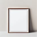 A minimalist blank wooden picture frame on a neutral wall, perfect for interior design concepts.
